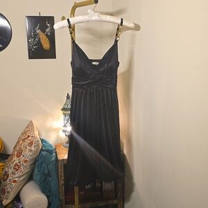 Little black satin dress with bubble hem skirt and chain strap detail